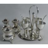 A Silver Plated Boiled Egg Cruet with Spoons Together with a Silver Plated Three Piece Cruet