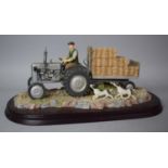 A Leonardo Collection Farming Figure Group, Tractor, Trailer and Terriers, on Wooden Plinth, 31cm