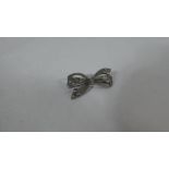 A Small Silver Brooch in the Form of a Bow