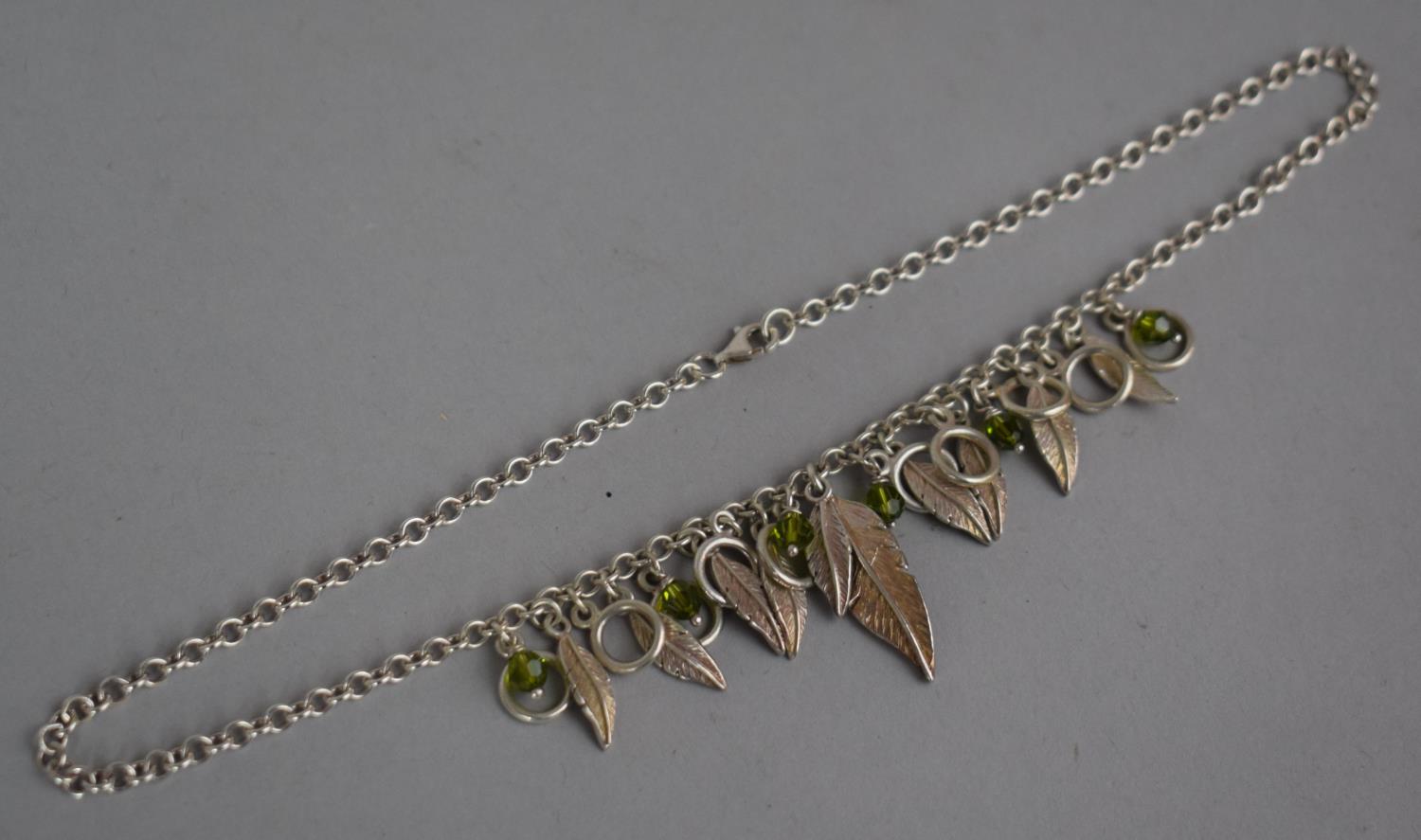 A Silver Necklace with Feather and Green Bead Decoration