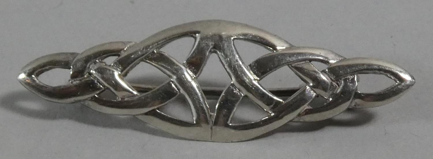 A Silver Brooch in the Form of a Knot