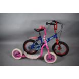 A Child's Superman Bicycle and a Girls Scooter