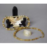 An Interesting Carved Shell Necklace in the Form of an Eagle together with a Carved Shell Ring