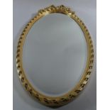 An Oval Gilt Framed Wall Mirror with Bevelled Glass, 61cm High