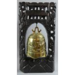 A Carved and Pierced Oriental Stand Supporting Brass Temple Bell Decorated in Relief with Dragon