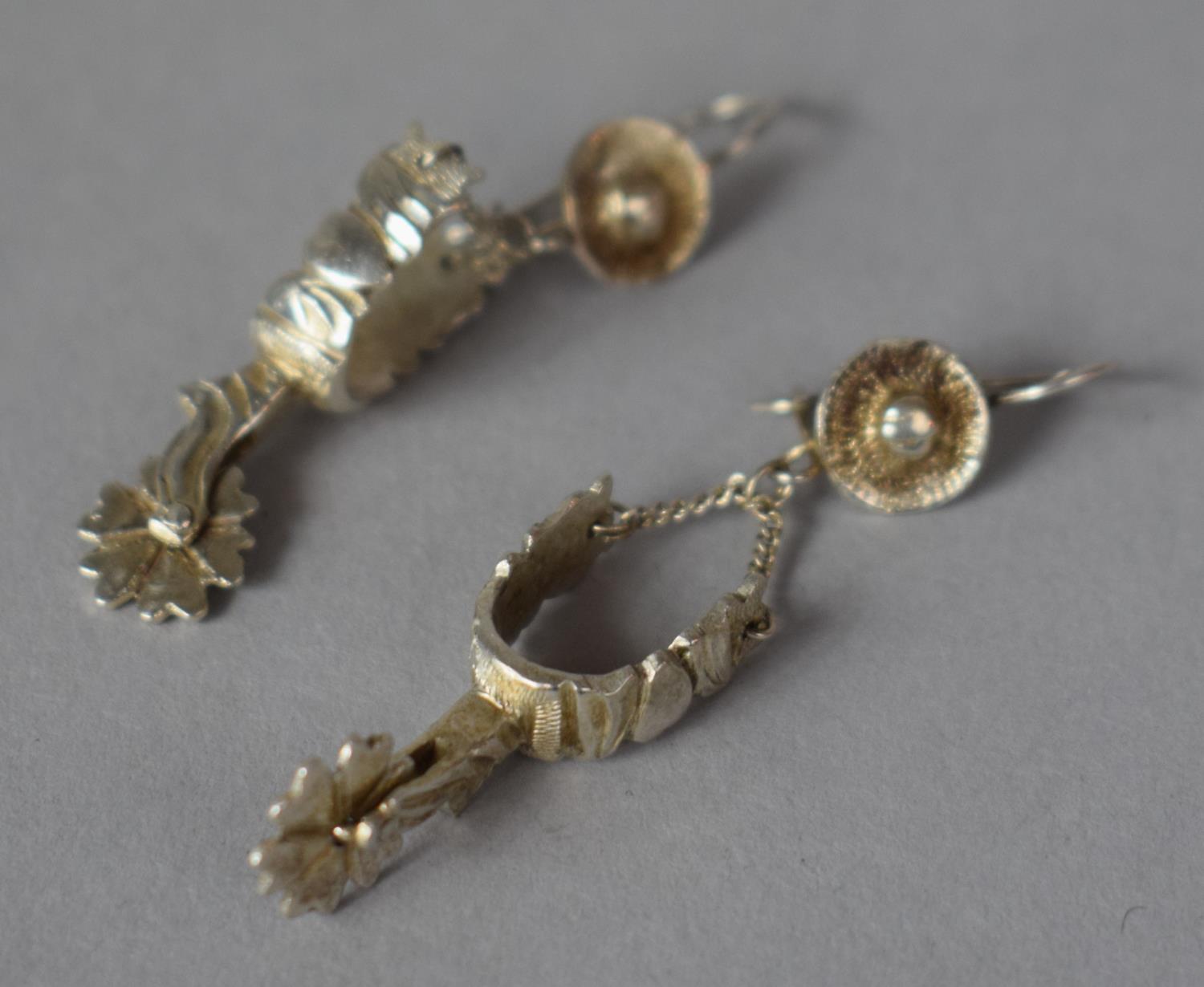 A Pair of Silver Novelty Earrings in the Form of Spurs and Cowboy Hats, Stamped 925