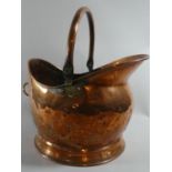 A Copper Helmet Shaped Coal Scuttle, 37cm high