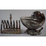 A Silver Plated Six Slice Toast Rack Together with a Silver Plated Nautilus Shell Spoon Warmer