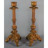 A Pair of Gold Sprayed Metal Candle Sticks on Tripod Bases, 28cm High