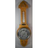 A Mid 20th Century Light Oak Aneroid Wheel Barometer with Temperature Scale