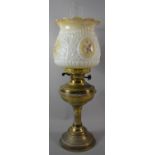 A Brass Oil Lamp with Opaque Glass Shade and Chimney