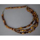 A Triple String of Tigers Eye Beads with Silver Clasp