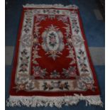 A Rectangular Woollen Chinese Rug on Red Ground, 160x92cm