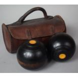 A Pair of Turned Wooden Lawn Bowls in Leather Case