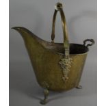 A Reproduction Beaten Brass Helmet Shaped Coal Scuttle with Ceramic Handle
