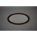 An Edwardian Oval Oak Framed Wall Mirror with Bevelled Glass, 81cm wide