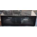 A Modern Wide Screen TV Stand with Glazed Pull Down Front to DVD and Other Accessory Cabinet,