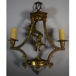 A Mid 20th Century Gilt Metal Two Branch Ceiling Chandelier with Cherub on Swing, 45cm high