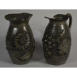 A Giselle Main, Signed and Stamped Pewter Jug Decorated in Relief with Grapes and a Similar Vase
