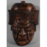 A Carved Wooden Souvenir Oriental Facemask, 25cm High