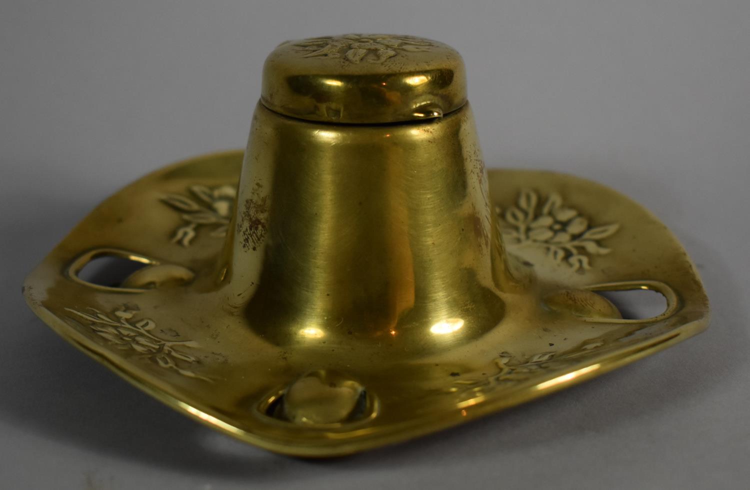 A Pressed Brass Desktop Inkwell with Embossed Floral Decoration, 13cm Diameter