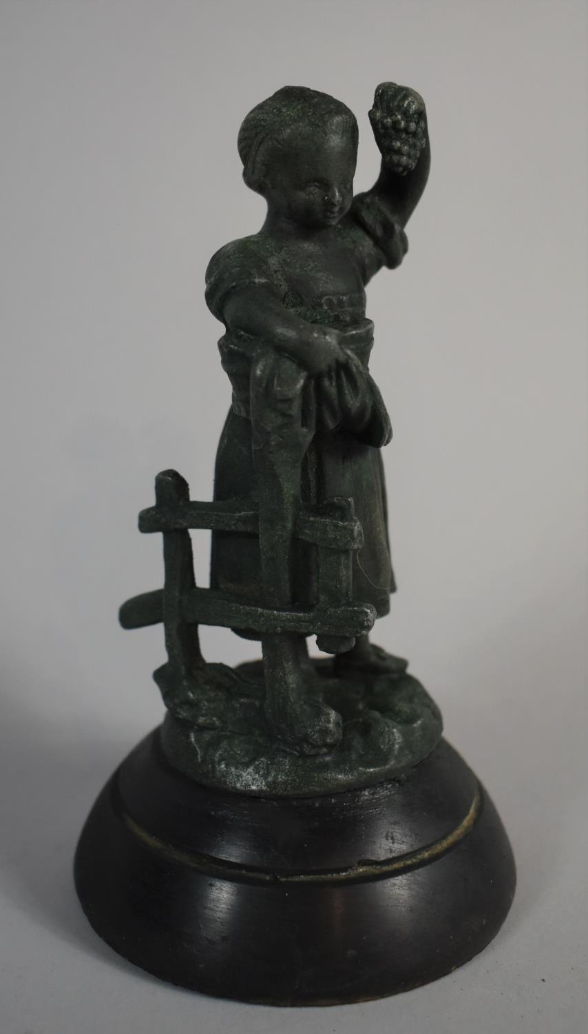 A Green Patinated Spelter Figure of a Young Girl Picking Bunch of Grapes, Circular Plinth, 17cm high