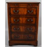 A Reproduction Mahogany Music Cabinet in the Form of a Four Drawer Chest with Brushing Slide Over by