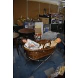 A Wicker Moses Basket on Chromed Stand Containing Various Vintage Dolls