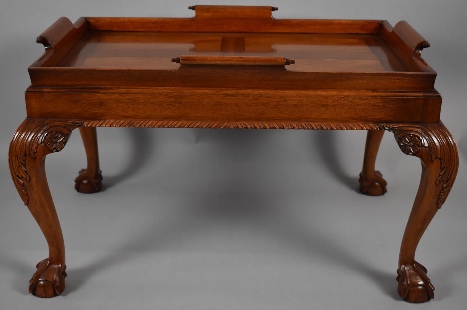 A Reproduction Mahogany Rectangular Tray on Stand with Cabriole Supports Culminating in Claw and