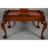 A Reproduction Mahogany Rectangular Tray on Stand with Cabriole Supports Culminating in Claw and