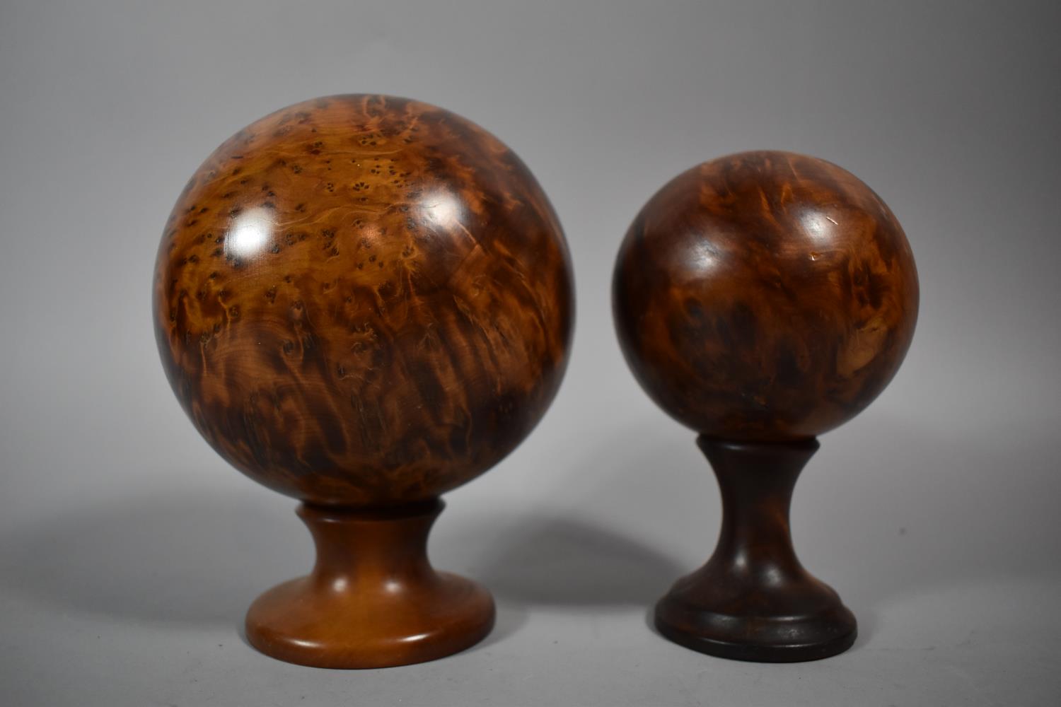 Two Thuja Wood Spheres on Circular Stands, The Largest 13cm Diameter