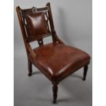 An Edwardian Hide Effect Upholstered and Carved Nursing Chair