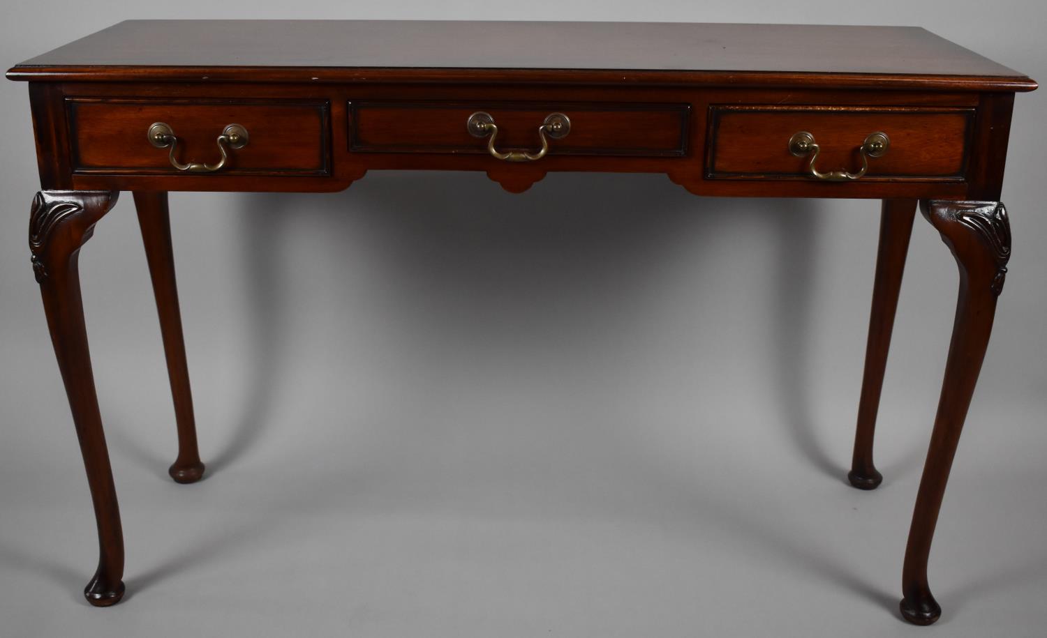 A Reproduction Three Drawer Mahogany Side Table on Cabriole Supports, 122cm Wide