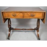 A Reproduction Mahogany Two Drawer Drop Leaf Sofa Table on Lyre Supports and Claw Casters, 90cm Wide