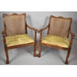 A Pair of Edwardian Oak Framed Cane Seated Low Armchairs