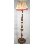 A Gilt Decorated Turned Wooden Standard Lamp and Shade