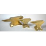 A Collection of Three Brass Paperweights in the Form of Blacksmiths' Anvils, One with Hinged Lid,