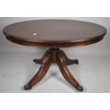 A Reproduction String Inlaid Oval Mahogany Coffee Table on Four Feet with Claw Casters, 91cm Wide