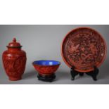 A Collection of Cinnabar Lacquer Style Items to Include Charger, Lidded Vase and Shaped Bowl