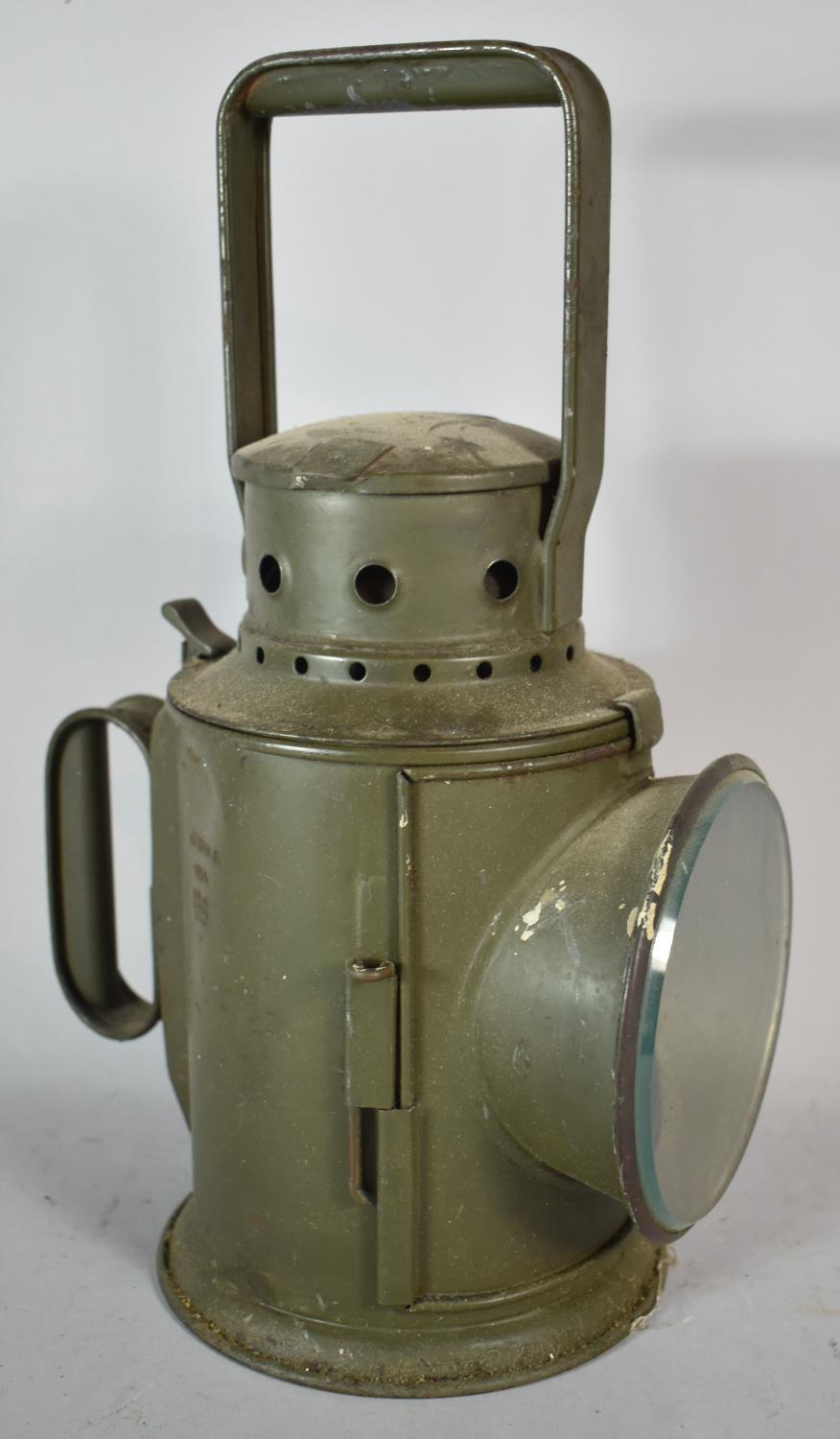 A Green Painted Railway Lamp Dated 1954 and with War Department Crows Foot Stamp, Complete with