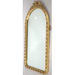 A Gilt Framed Arched Top Wall Mirror with Ribbon and Bow Finial, 69cm High