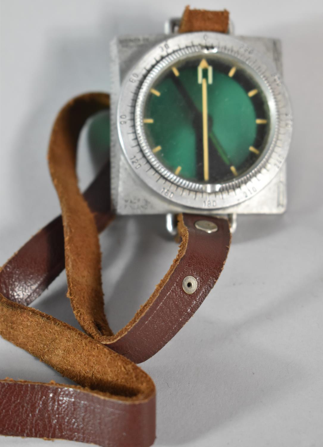 A Finnish Military Pilot's Compass with Wrist Strap, Stamped Suunto Oy, Helsinki