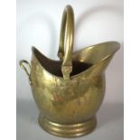 A Brass Helmet Shaped Coal Scuttle, 46cm high