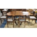 A Twin Pedestal Oval Mahogany Extending Dining Table with One Extra Leaf, Six Dining Chairs with