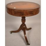 A Reproduction Circular Drum Table with Three Drawers On Tripod Support with Brass Claw Casters,