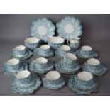 An Edwardian Blue Floral Tea Set by Chapman, with Shaped Lobed Form to comprise Twelve Cups,