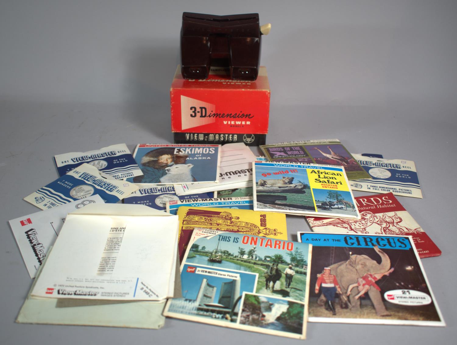A Viewmaster Viewer Together with a Collection of Stereo Picture Reels