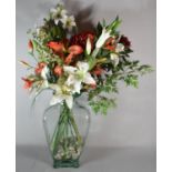 A Large Glass Vase Containing Pebbles and Artificial Flowers