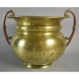 An Arts and Crafts Influenced Brass Planter with Copper Handles by William Souter and Sons, 24cms