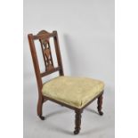 An Edwardian Walnut Framed Ladies Nursing Chair with Pierced Splat